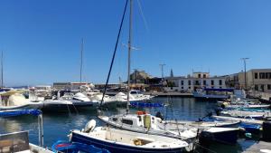 a bunch of boats are docked in a harbor at NULA Private Suites in Pozzuoli