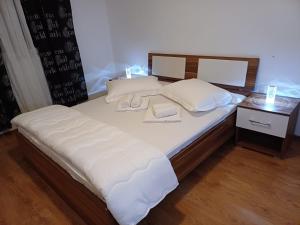 een bed met witte lakens en kussens erop bij Apartments with a parking space Podstrana, Split - 22374 in Podstrana