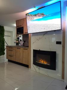 a living room with a fireplace and a flat screen tv at Apartments by the sea Selce, Crikvenica - 22726 in Selce