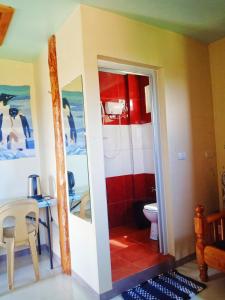 a bathroom with a toilet and a table at Aesthetic Infused with Rustic Vibe Rooms at BOONE'S in Sagada