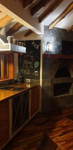 a kitchen with a stone fireplace in a room at Villa Valcore in Mérida