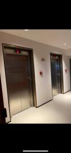 two elevators in a building with their doors open at RED DESIGN - Apto completo 2 Qts 901 in Vitória