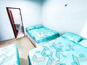 Ένα ή περισσότερα κρεβάτια σε δωμάτιο στο Hotel Palmahia Moñitos
