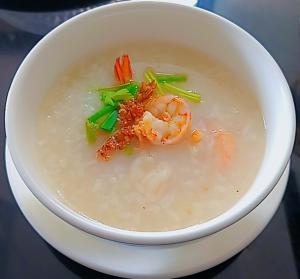 a bowl of soup with shrimp and vegetables in it at U Zone Hostel & Cafe in Surat Thani