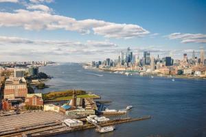 an aerial view of a city with a river at Modern 3 BR 3.5 BA Breathtaking in Jersey City