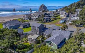 an aerial view of a neighborhood with houses and the ocean at Odyssey in Cannon Beach