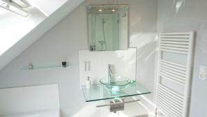 y baño con lavabo de cristal y espejo. en Fewo Aron, en Tönning 14 fotos más