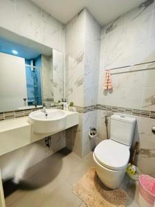 a bathroom with a toilet and a sink at lumpini park beach in Cha Am