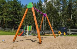 a playground with a swing set in a park at Beautiful Apartment In Sorkwity With House A Panoramic View in Sorkwity