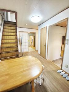 a conference room with a wooden table and a door at Pokémon Sleep 宝可梦的家 in Osaka