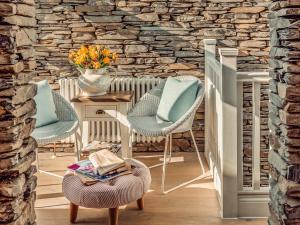 a living room with two chairs and a table at The Dormouse -uk46926 in Newby Bridge