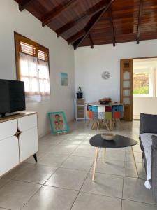 ein Wohnzimmer mit einem Sofa und einem Tisch in der Unterkunft KARIFUNA-II in Baie Mahault