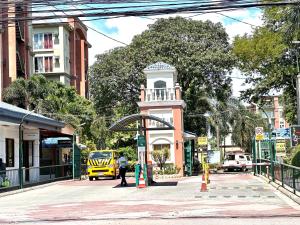 a building with a clock tower on a city street at Affordable Studio Unit at Chateau Elysee Lafayette cluster in Manila