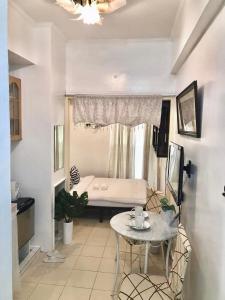 a small room with a small table and a bed at Affordable Studio Unit at Chateau Elysee Lafayette cluster in Manila