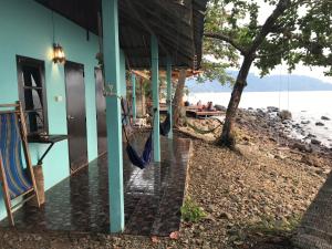a house with a hammock outside of it next to the water at Blue Sky Resort in Ko Chang +64 photos