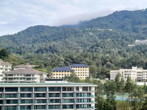 a group of buildings in front of a mountain at Windmill Upon Hills Genting Highland by Sweet Memory in Genting Highlands