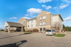 a building with a car parked in a parking lot at Country Inn & Suites by Radisson, South Haven, MI in South Haven