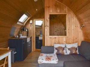 a living room with a couch in a tiny house at Black Coombe-uk1392 in Corney