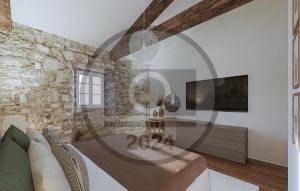 uma sala de estar com uma parede de pedra em Nice Home In Buzet With Kitchen em Buzet