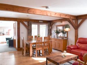 a living room with a table and a red couch at The Lodge in Gloucester