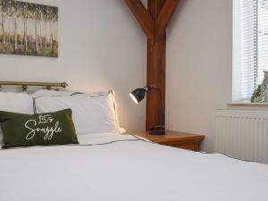 a bedroom with a bed with a green pillow at The Lodge in Gloucester