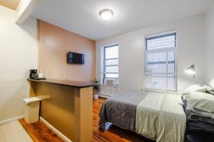 a bedroom with a bed and a desk in it at Park Side Living, Get Cozy in New York
