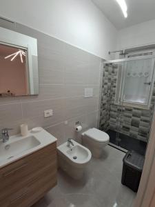 a bathroom with a sink and a toilet and a shower at Rovelli House in Foggia