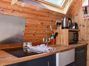 a kitchen with a sink in a tiny house at Stainton-uk1395 in Corney
