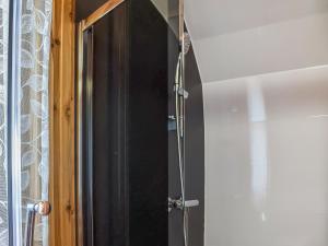 a shower with a glass door in a bathroom at Stainton-uk1395 in Corney