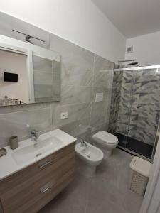 a bathroom with a sink and a toilet and a shower at Rovelli House in Foggia