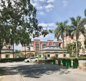 a building with a car parked in a parking lot at Affordable Studio Unit at Chateau Elysee Lafayette cluster in Manila