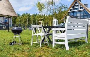 a grill and two chairs and a table and a grill at 2 Bedroom Stunning Apartment In Sorkwity in Sorkwity