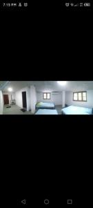 a picture of a room with two beds in it at New Samanalee Resort in Kataragama