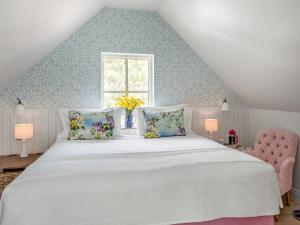a bedroom with a large white bed and a window at The Owl Nest-uk46927 in Newby Bridge