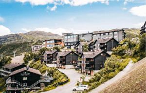 a group of houses on a hill with a car at Gorgeous Apartment In Hemsedal With Wifi in Hemsedal