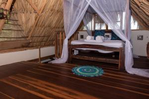 a bedroom with a bed in a tent at Casa Surf Mar Azul in Palomino