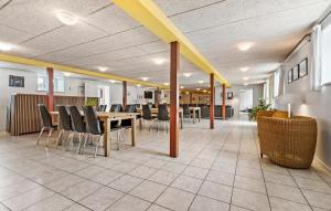 a dining room with a table and chairs at 11 Bedroom Pet Friendly Home In Rønde in Rønde