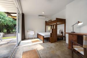 a bedroom with a bunk bed and a desk at Jasper Cub in Wilpattu