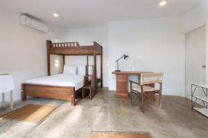 a bedroom with a bed and a desk and a bed and a desk at Jasper Cub in Wilpattu