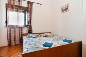 um quarto com uma cama com almofadas azuis em Ferienwohnung für 4 Personen ca 50 qm in Peroj, Istrien Istrische Riviera em Peroj