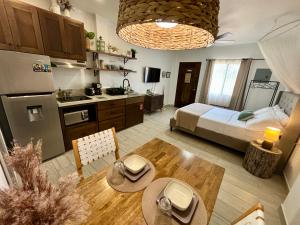 a kitchen and a living room with a bed and a table at Stylish Apartments near Best Western Hotel in Belize City