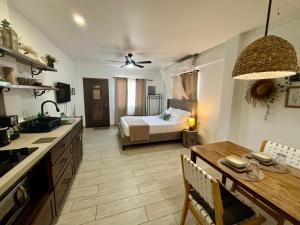 a kitchen and living room with a bed and a table at Stylish Apartments - 10 Minutes to Airport & Water Taxi, close to Best Western in Belize City
