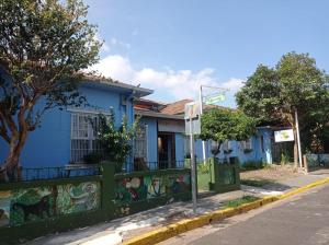 a blue building on the side of a street at Hostel Casa Ridgway in San José
