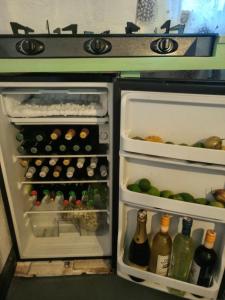 an open refrigerator filled with lots of bottles of wine at Akagera guide's House in Kabarondo