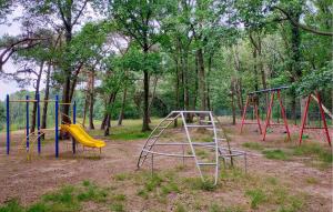 an empty playground with two swings and a slide at 2 Bedroom Beautiful Home In Well in Well