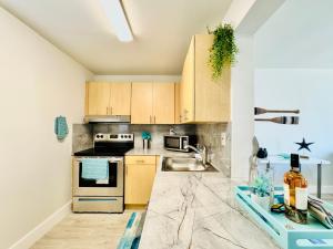 A kitchen or kitchenette at Coastal Charm: Waterfront with Free Parking - Walk to Beach