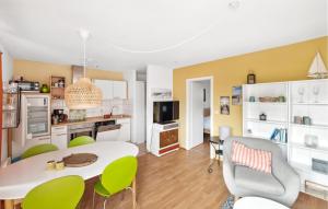 a kitchen and living room with a table and chairs at Seeigel in Süssau