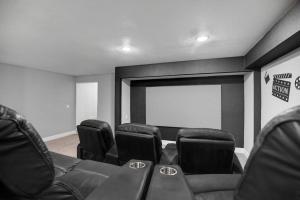 a cinema room with black chairs and a screen at HUGE Golf course Family home-FREE Heated Pool-Theater-Gym in Tempe +68 photos