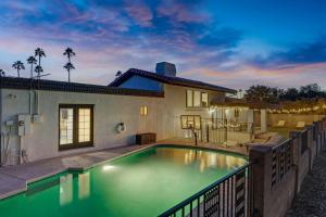 a swimming pool in the backyard of a house at HUGE Golf course Family home-FREE Heated Pool-Theater-Gym in Tempe