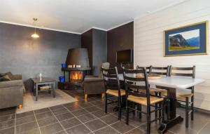 a living room with a table and chairs and a fireplace at Awesome Apartment In Hemsedal With Kitchen in Hemsedal